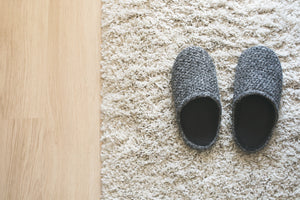 Photo of cozy slippers with definition of hygge